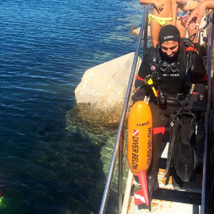 Foto di un maestro di sub che sta per entrare in acqua e procedere con l'insegnamento delle attività subacquee a tutti anche alle persone con disabilità, rendendo quindi le immersioni accessibili.